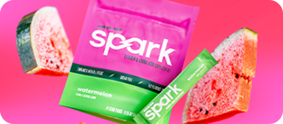 Spark Watermelon Gusset Bag and stick bag surrounded by watermelon slices on a pink background.