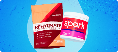 Rehydrate Pomegranate Tangerine Gusset bag and Spark Fruit Punch Canister on a blue background with water droplets.