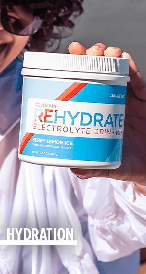 Hydration - a woman holding up a canister of Rehydrate Berry Lemon Ice