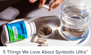 5 Things We Love About Synbiotic Ultra™  - bottle of Synbiotic Ultra on table with pills spilling out next to a glass of water