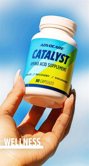Wellness - a manicured hand holding up a bottle of AdvoCare Catalyst