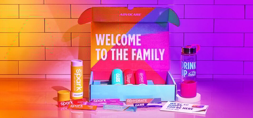 AdvoCare Preferred Customer Welcome Box on a kitchen counter backlight by purple and orange
