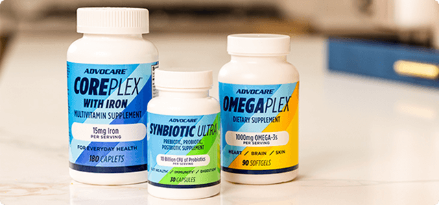 AdvoCare Synbiotic Ultra, OmegaPlex and CorePlex with Iron bottles sitting on a kitchen counter.