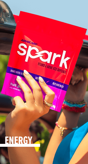 Energy - A person holding up a bag of Spark Fruit Punch