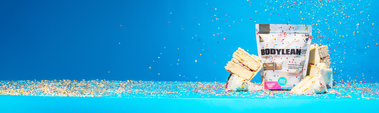 A BodyLean25® Birthday Cake gusset bag surrounded by confetti and cake slices.