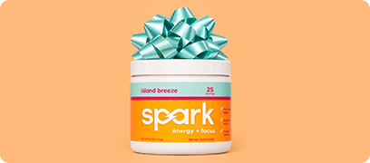 A Spark&reg; Island Breeze canister with a blue bow on top of it.