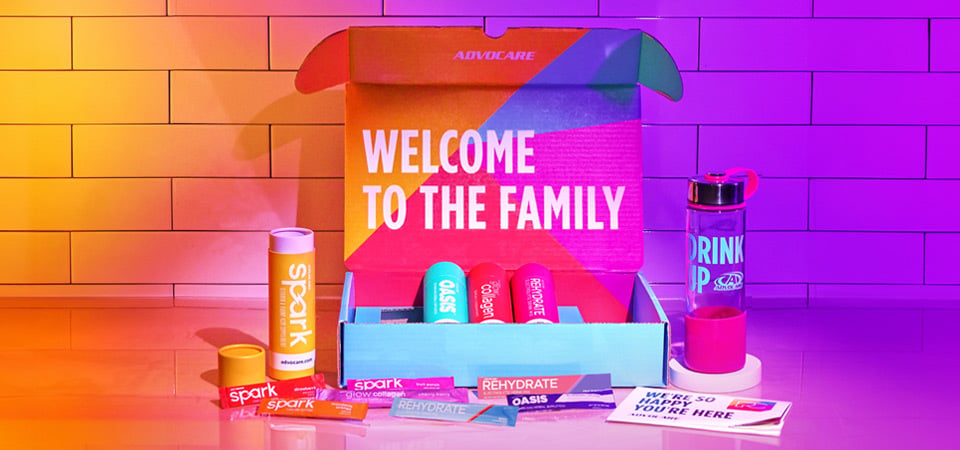 AdvoCare Preferred Customer Welcome Box on a kitchen counter backlight by purple and orange