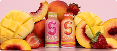 AdvoCare Slam Peach Mango + Strawberry Guava bottles surrounded by sliced fruit on a pink background.